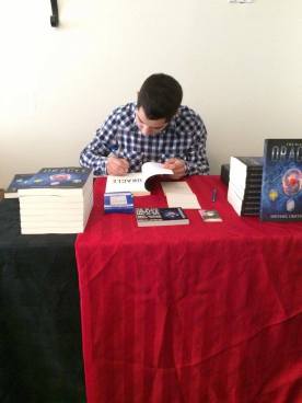 Signing the first copy of The Black Oracle.